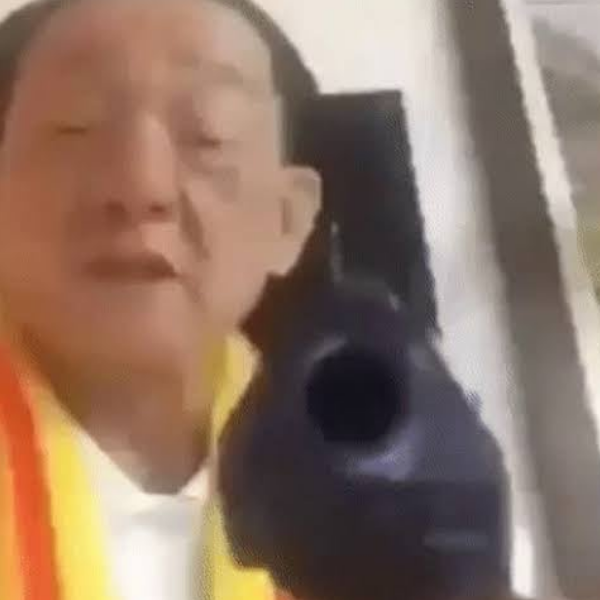 old Asian guy with gun